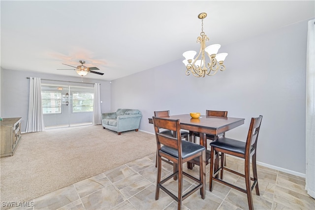 dining area featuring light colored carpet and ceiling fan with notable chandelier