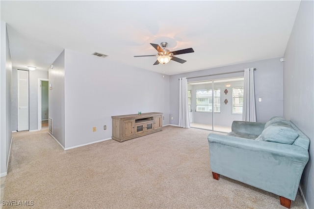 living room with light carpet and ceiling fan