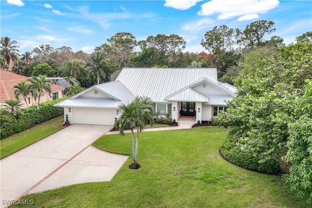 view of front of home featuring a front yard and a garage