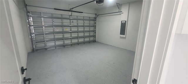 garage with a garage door opener and electric panel