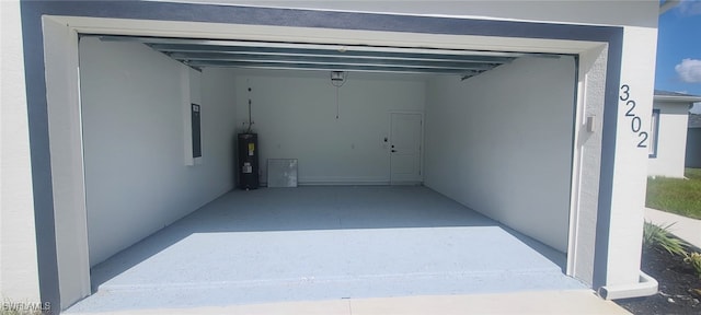 garage featuring water heater and electric panel