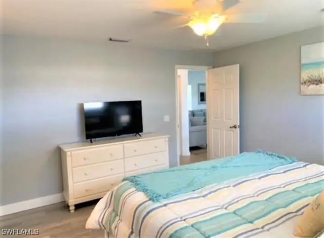 bedroom with light wood-type flooring and ceiling fan