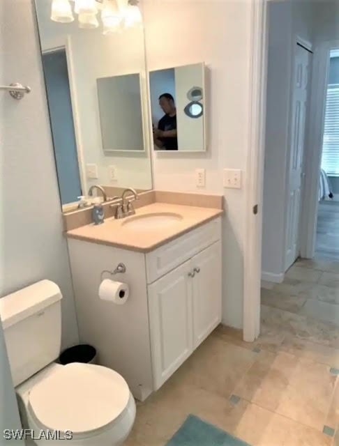 bathroom with toilet and vanity