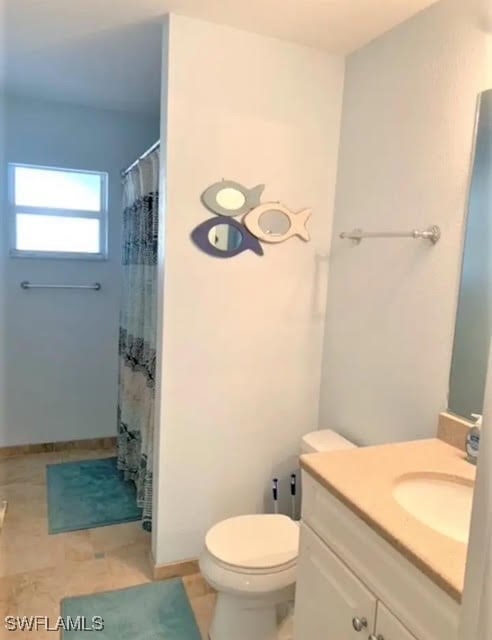 bathroom with vanity, a shower with curtain, and toilet