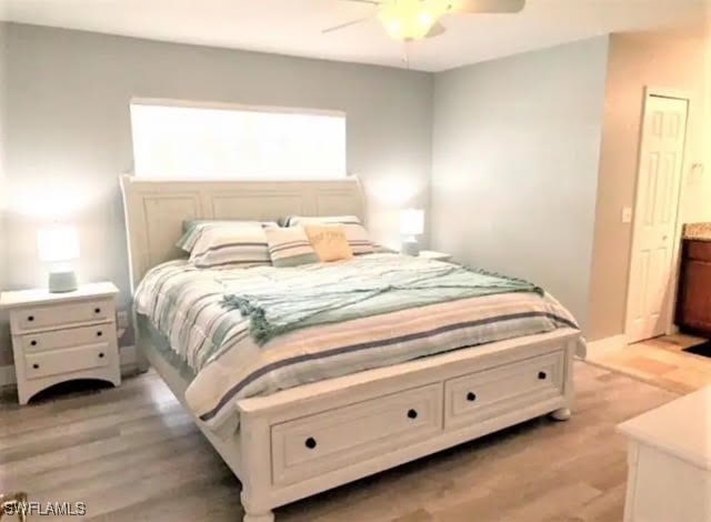 bedroom with light hardwood / wood-style floors and ceiling fan