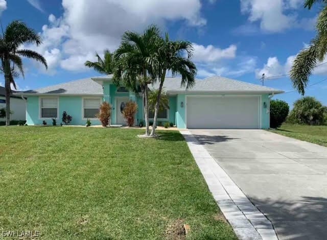 ranch-style house featuring a front lawn and a garage