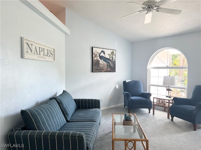 living room with carpet floors, ceiling fan, and vaulted ceiling