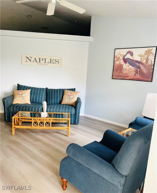 living room with lofted ceiling and hardwood / wood-style flooring