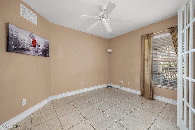 empty room featuring light tile patterned floors and ceiling fan