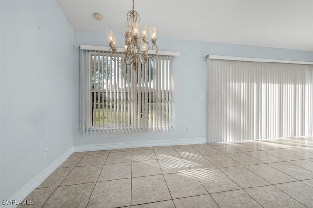 unfurnished dining area with light tile patterned floors and a chandelier