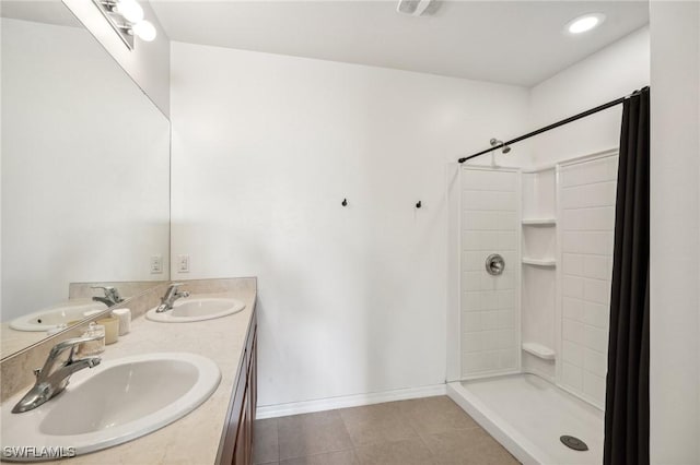 bathroom with baseboards, a sink, and a shower stall