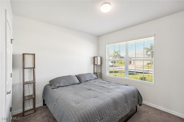 bedroom with carpet and baseboards