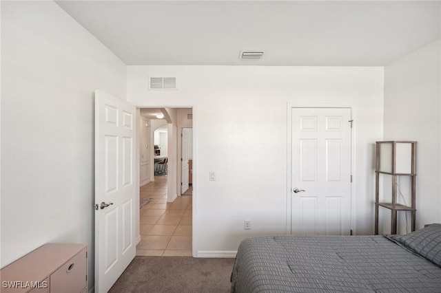 bedroom with arched walkways, light carpet, and visible vents