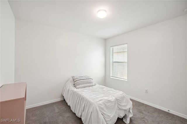 bedroom featuring carpet and baseboards