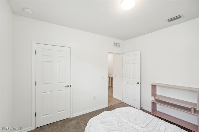 bedroom with carpet floors, visible vents, and baseboards