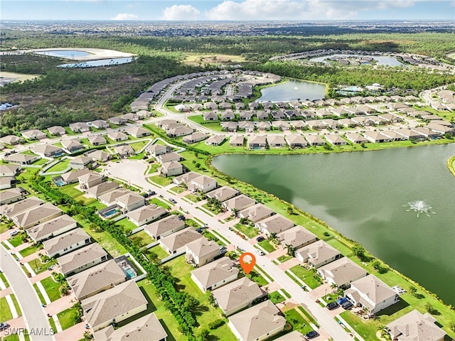 drone / aerial view with a water view and a residential view