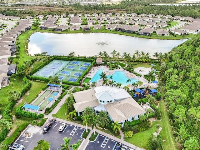 birds eye view of property with a water view and a residential view