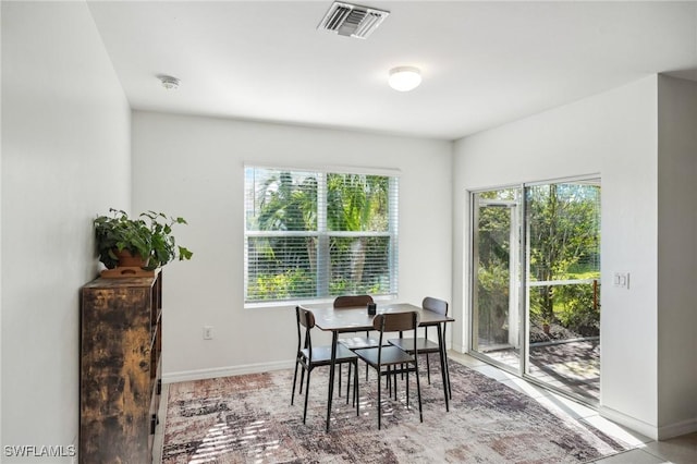 dining space with a healthy amount of sunlight, baseboards, and visible vents