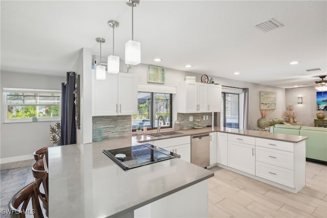 kitchen featuring kitchen peninsula, tasteful backsplash, white cabinetry, dishwasher, and pendant lighting