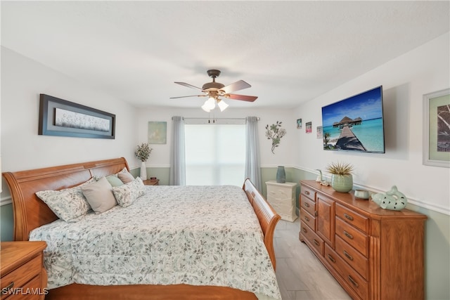 bedroom featuring light wood-type flooring and ceiling fan