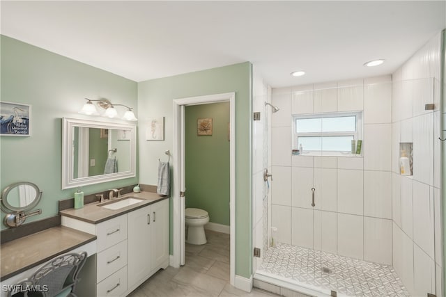 bathroom with a shower with door, toilet, and vanity