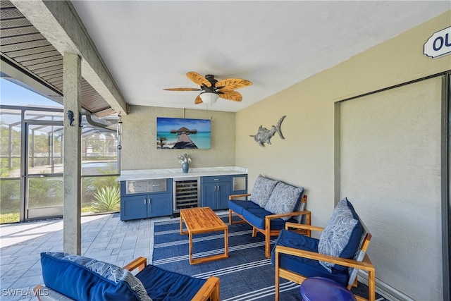 sunroom featuring ceiling fan, a healthy amount of sunlight, and beverage cooler