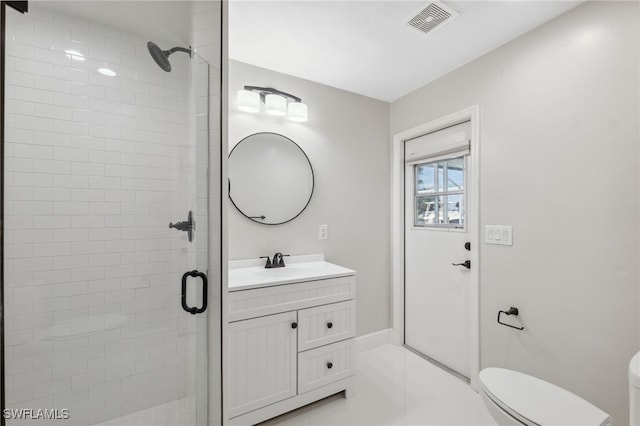 bathroom with tile patterned floors, vanity, toilet, and an enclosed shower