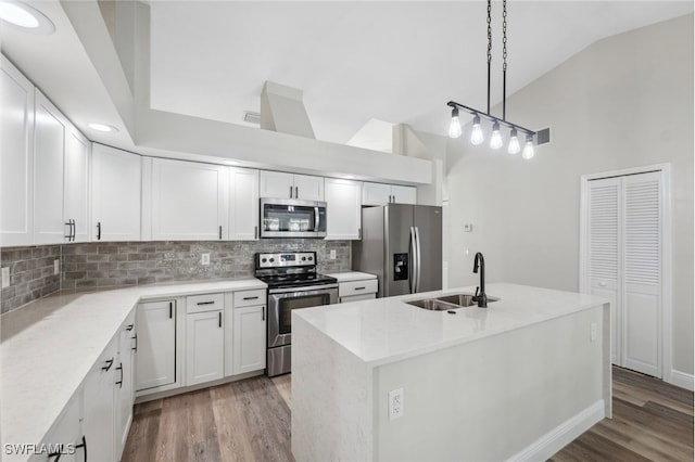 kitchen with sink, white cabinetry, stainless steel appliances, and light hardwood / wood-style flooring