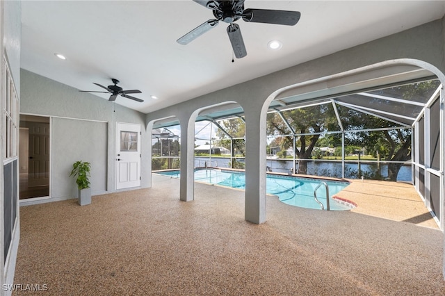 view of pool with ceiling fan and a water view