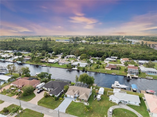 aerial view at dusk with a water view