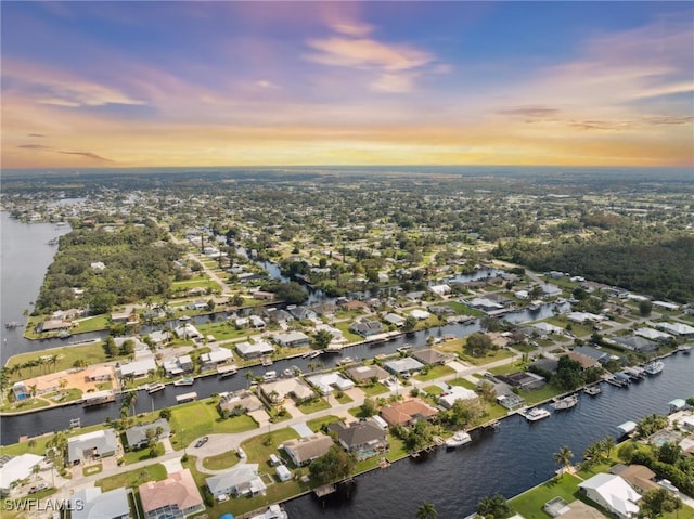 aerial view at dusk with a water view