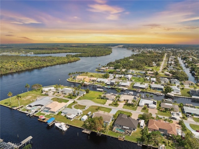 aerial view at dusk with a water view