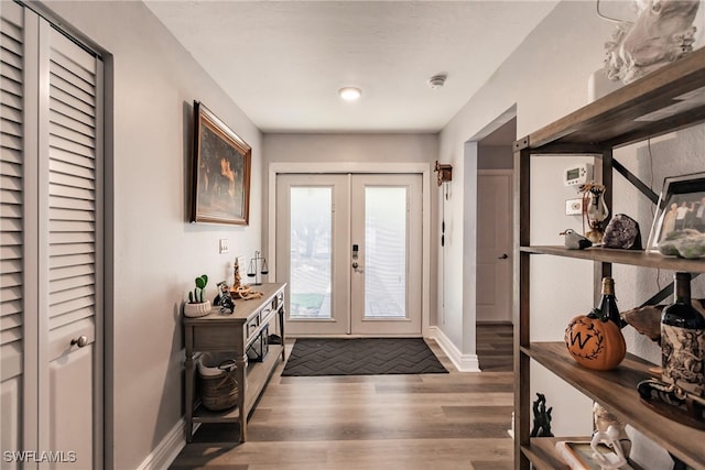 foyer entrance featuring french doors and dark hardwood / wood-style flooring