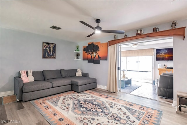 living room with ceiling fan and hardwood / wood-style floors