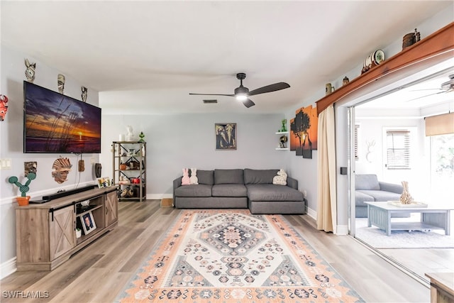 living room featuring ceiling fan and light wood-type flooring