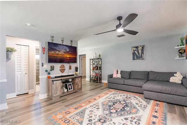 living room featuring ceiling fan and light wood-type flooring