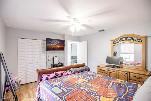 bedroom with light hardwood / wood-style floors, a closet, and ceiling fan