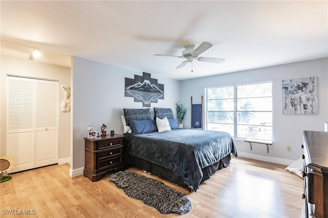 bedroom featuring light hardwood / wood-style flooring, a closet, and ceiling fan