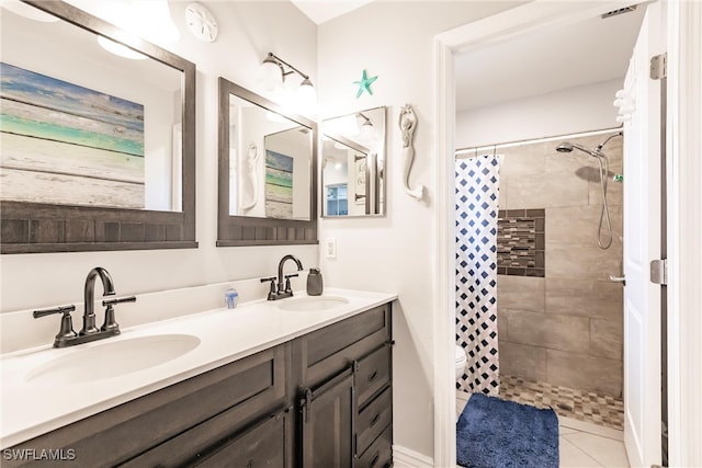 bathroom featuring vanity, curtained shower, toilet, and tile patterned flooring