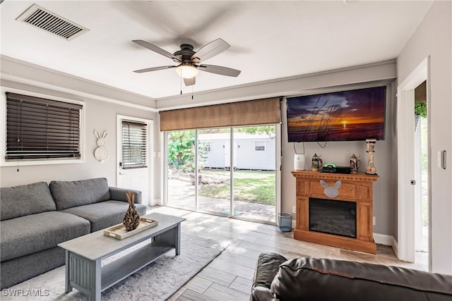 living room with light hardwood / wood-style floors and ceiling fan