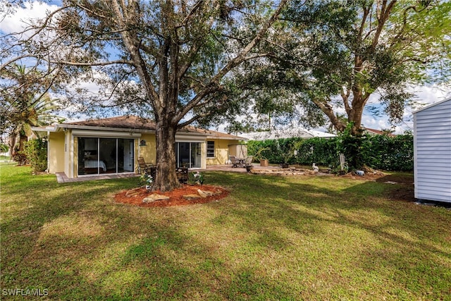 rear view of property with a patio area and a lawn