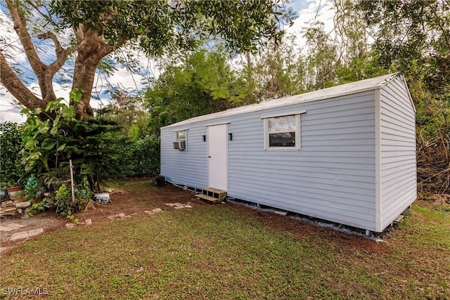 view of outbuilding featuring a yard