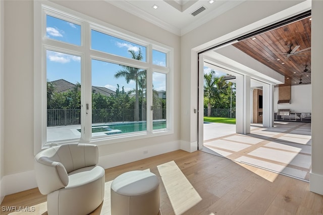 doorway featuring crown molding and light hardwood / wood-style flooring