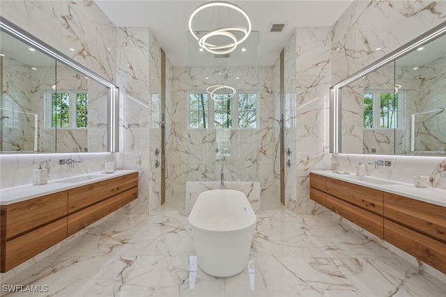 bathroom featuring tile walls, vanity, and a healthy amount of sunlight