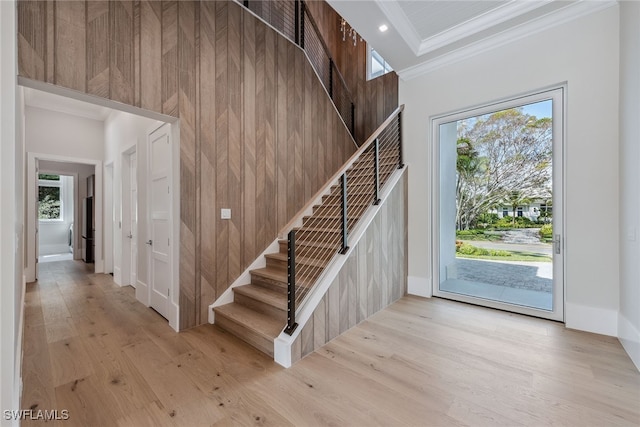 interior space featuring crown molding, light wood-type flooring, and plenty of natural light