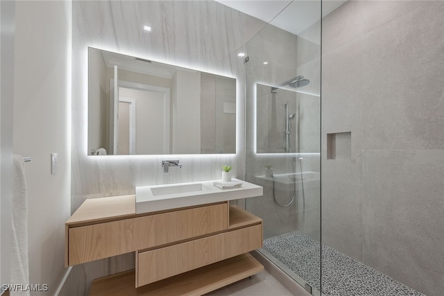 bathroom with vanity and tiled shower