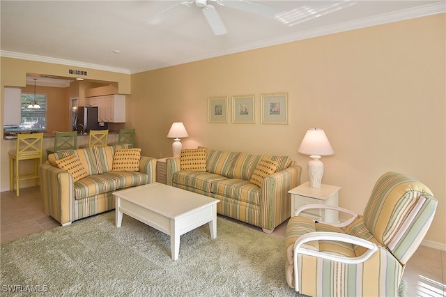 living room featuring crown molding, light tile patterned flooring, and ceiling fan