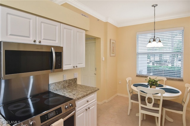 kitchen with white cabinetry, stainless steel appliances, ornamental molding, and decorative light fixtures