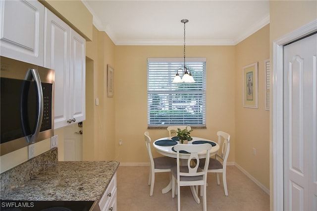 dining room featuring crown molding, an inviting chandelier, and light tile patterned floors