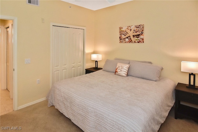 bedroom featuring a closet and light carpet